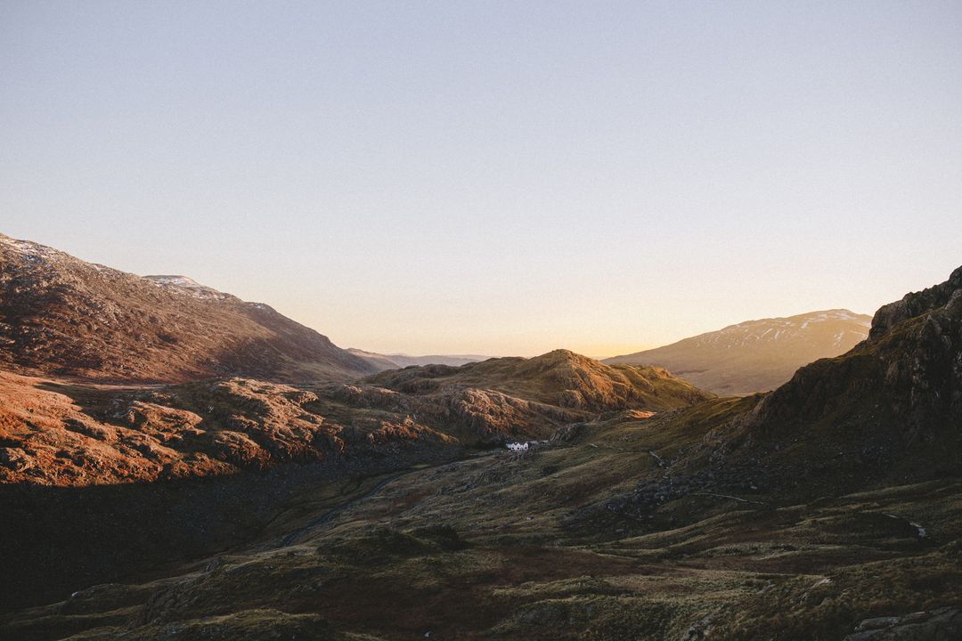 Serene Mountain Range at Sunrise with Golden Light