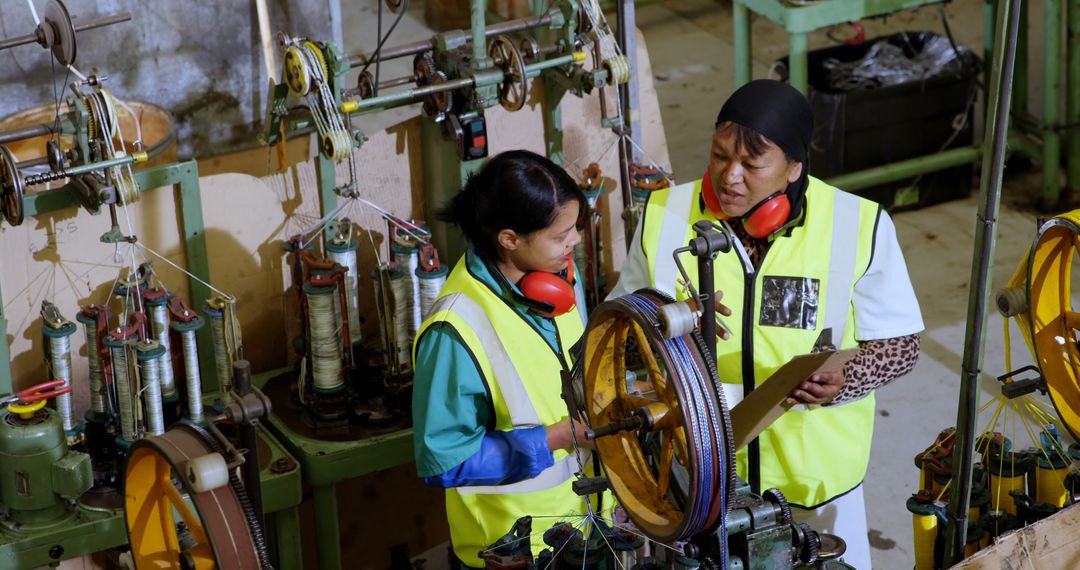 Women Engineers Discussing Work on Manufacturing Floor - Free Images, Stock Photos and Pictures on Pikwizard.com