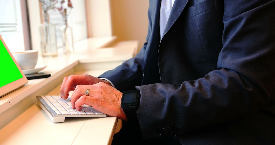 Businessman Typing on Wireless Keyboard at Office Desk - Free Images, Stock Photos and Pictures on Pikwizard.com