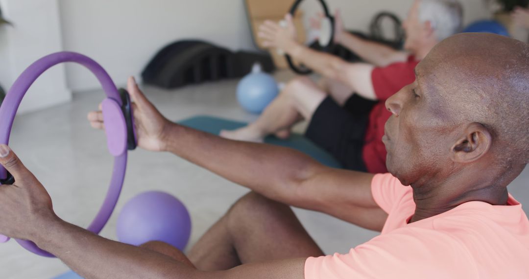 Senior Individuals Engaging in Pilates with Exercise Rings - Free Images, Stock Photos and Pictures on Pikwizard.com