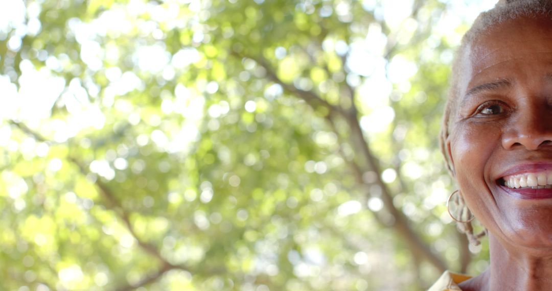 Smiling Elderly Woman Outdoors in Sunlight - Free Images, Stock Photos and Pictures on Pikwizard.com