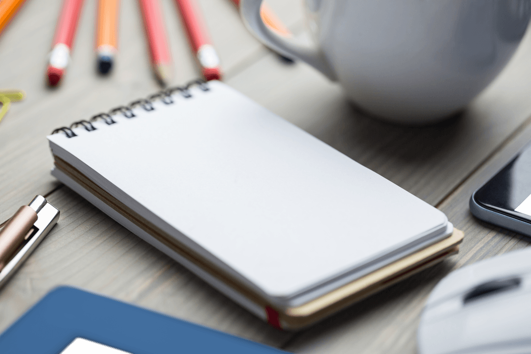 Transparent Notepad on Office Desk with Pencils and Pen