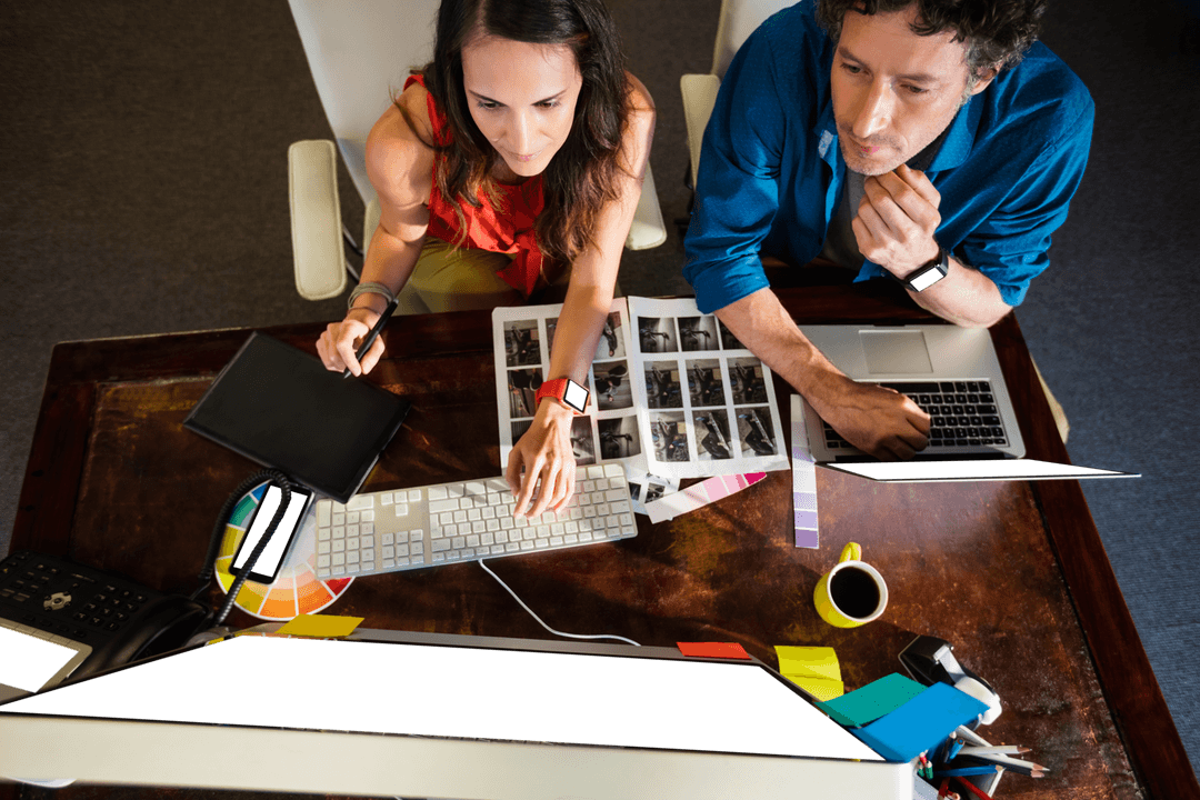 Colleagues Collaborating with Graphics Pad at Work, Top View