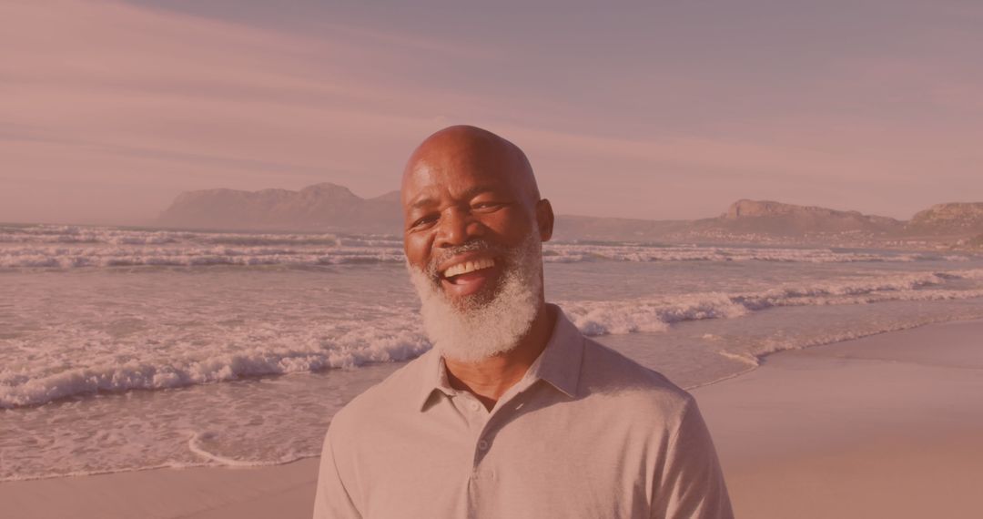 Senior Man Enjoying Peaceful Beach Walk at Sunset