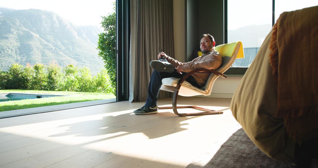 Relaxed Man in Modern Home with Scenic Mountain View