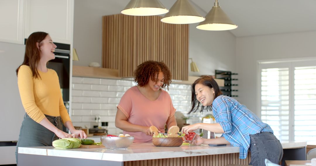 Diverse Friends Enjoy Cooking and Smiling in Bright Kitchen