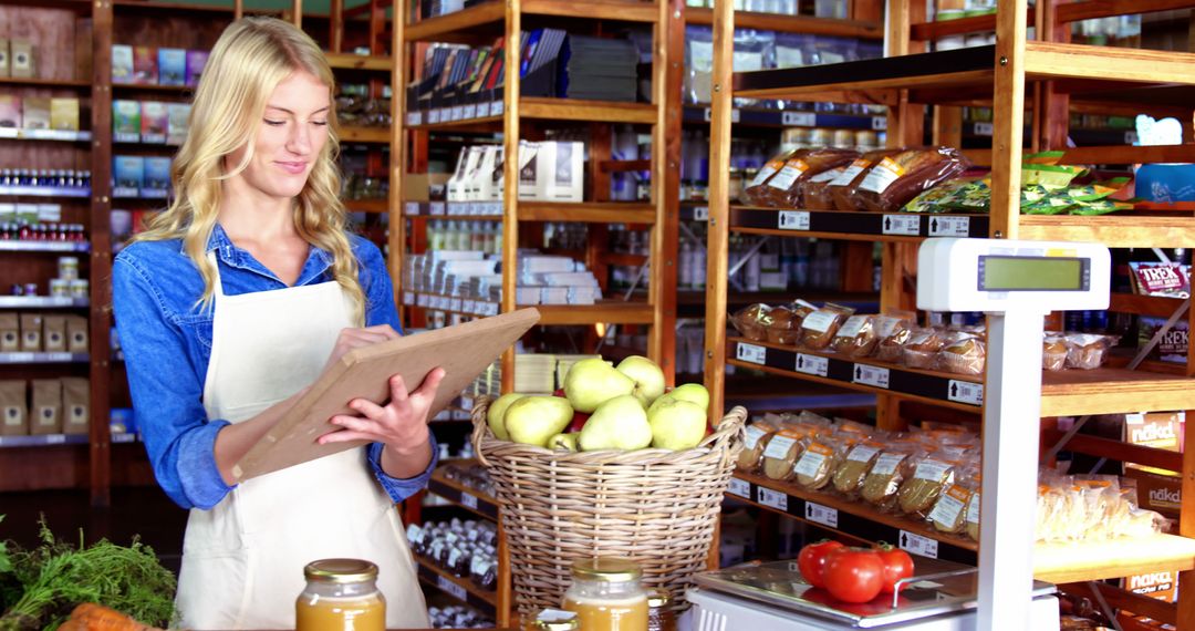 Female Shopkeeper Taking Inventory in Organic Grocery Store - Free Images, Stock Photos and Pictures on Pikwizard.com