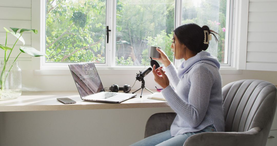 Woman Working from Home with Laptop and Phone by Window - Free Images, Stock Photos and Pictures on Pikwizard.com