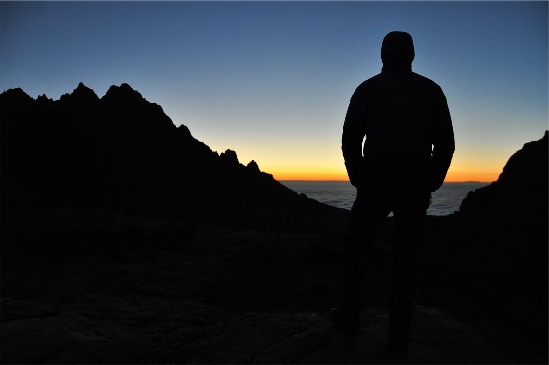 Silhouette of Hiker Watching Sunrise over Mountain Ridge - Free Images, Stock Photos and Pictures on Pikwizard.com