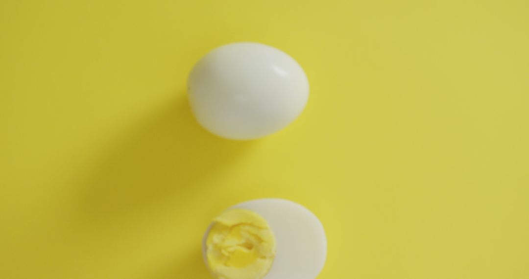 Boiled Egg Halves on Bright Yellow Background - Free Images, Stock Photos and Pictures on Pikwizard.com