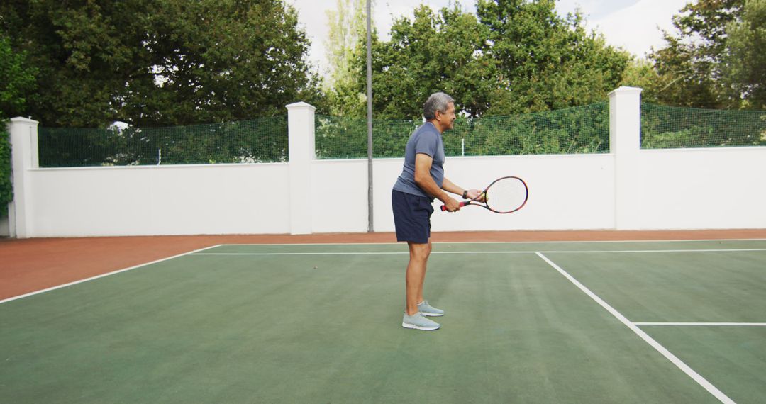 Senior Player Practicing Tennis on Outdoor Court - Free Images, Stock Photos and Pictures on Pikwizard.com