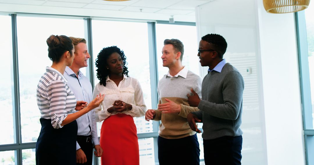 Diverse Professionals Engaging Discussing Ideas in Modern Office
