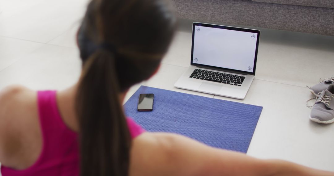 Woman Doing At-Home Workout with Laptop and Smartphone - Free Images, Stock Photos and Pictures on Pikwizard.com