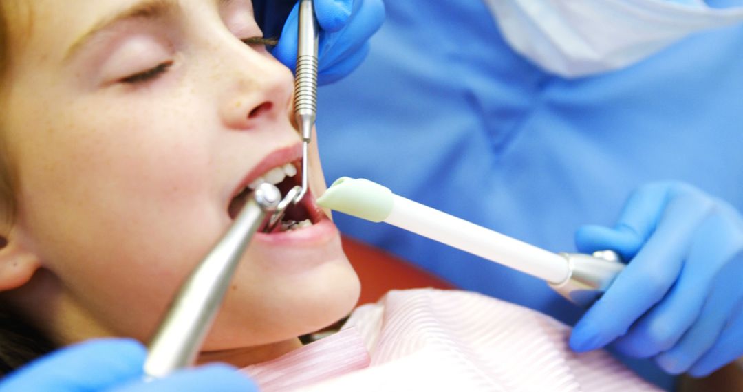 Child Receiving Dental Treatment from Professional Dentist in Clinic - Free Images, Stock Photos and Pictures on Pikwizard.com