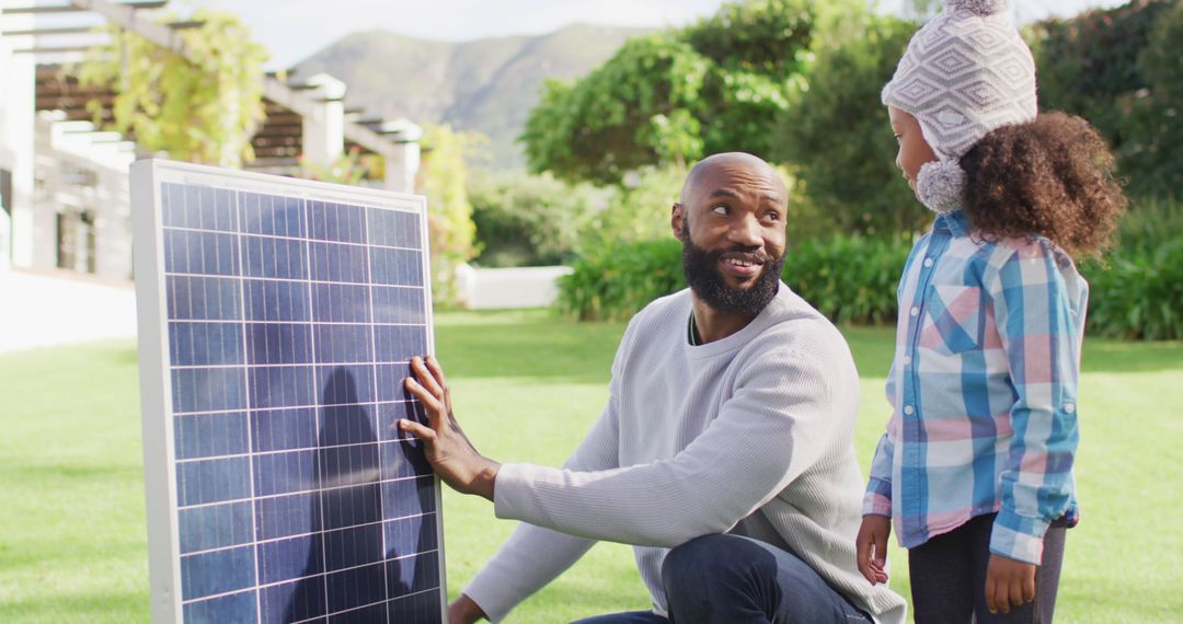 Father Teaching Daughter About Solar Panels in Garden - Free Images, Stock Photos and Pictures on Pikwizard.com