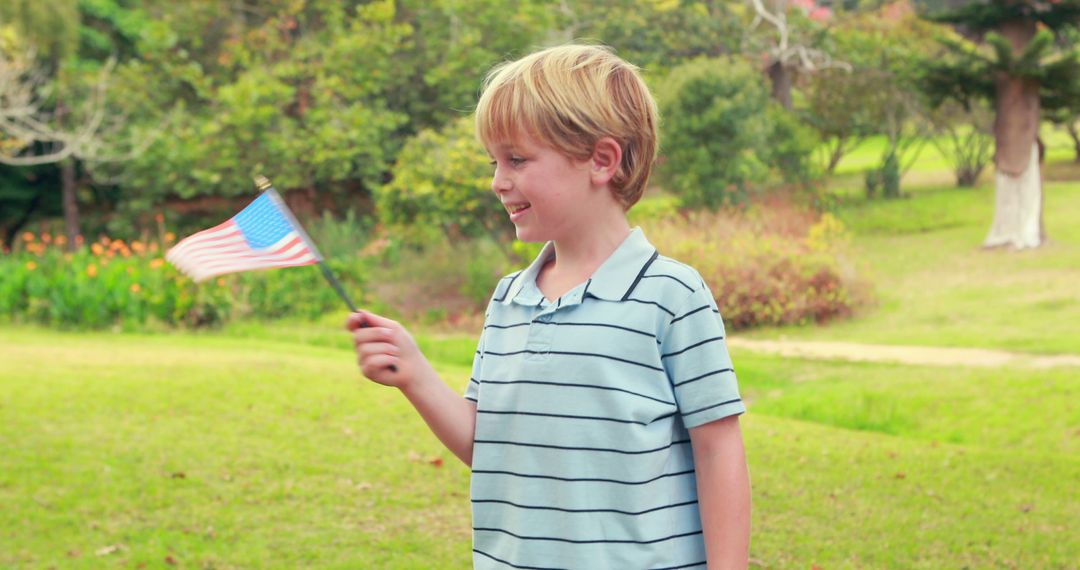 Young Boy Waving American Flag at Park - Free Images, Stock Photos and Pictures on Pikwizard.com