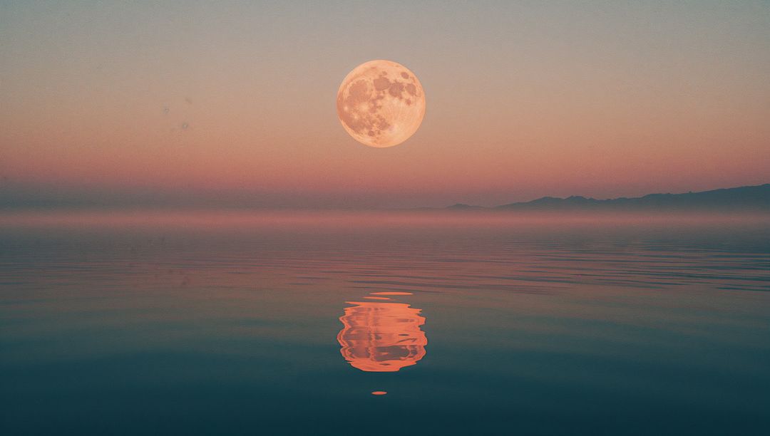 Full Moon Reflection Over Calm Sea During Twilight