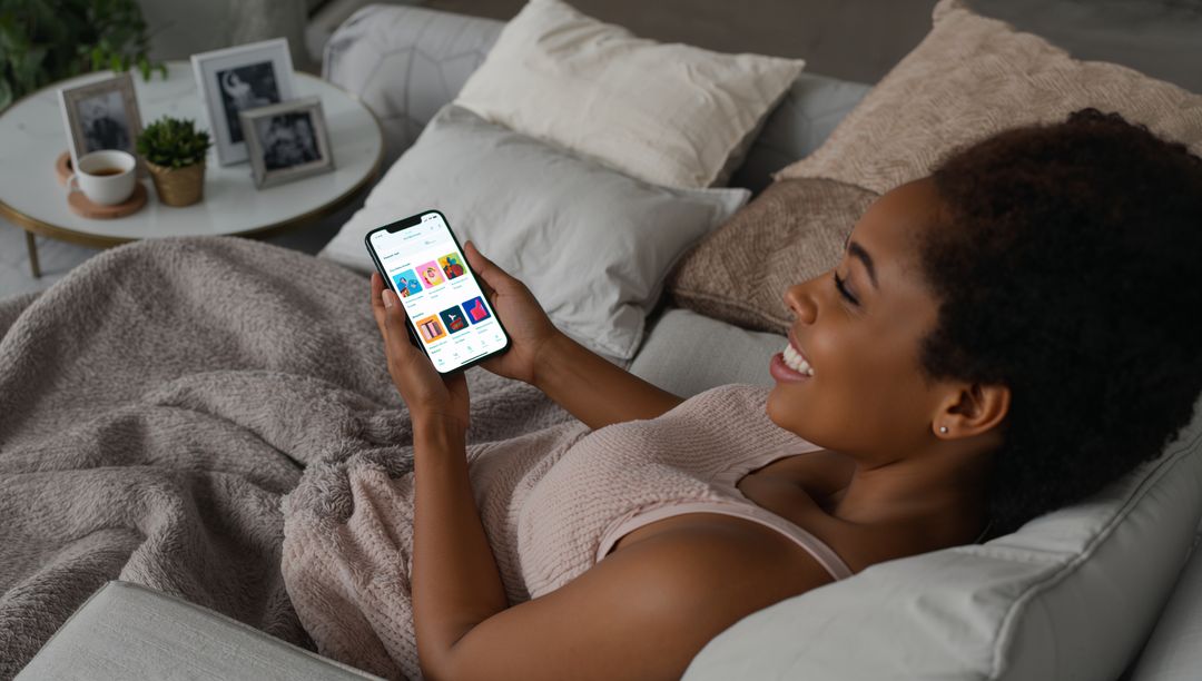 Smiling Woman Relaxing at Home Browsing on Smartphone