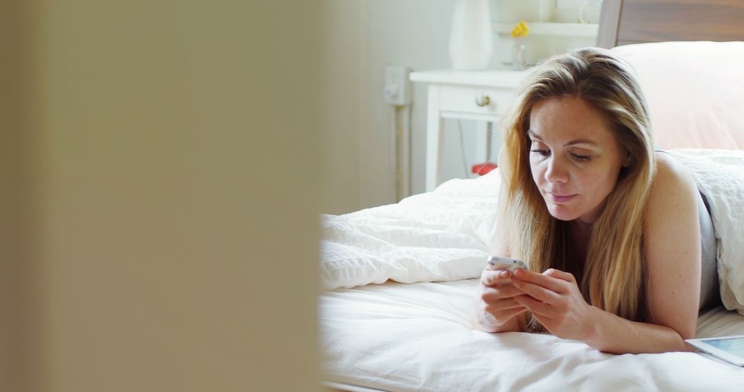 Young Woman Relaxing in Bed Using Smartphone at Home - Free Images, Stock Photos and Pictures on Pikwizard.com