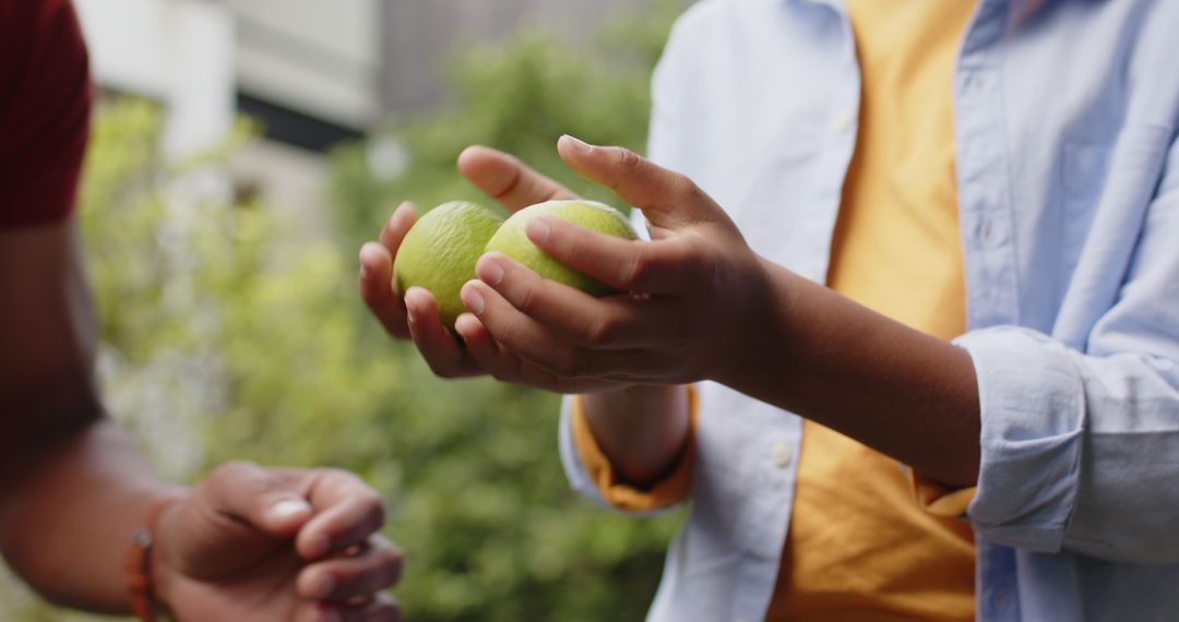 Father and Son Bonding in Garden Holding Limes Expressing Leisure and Connection