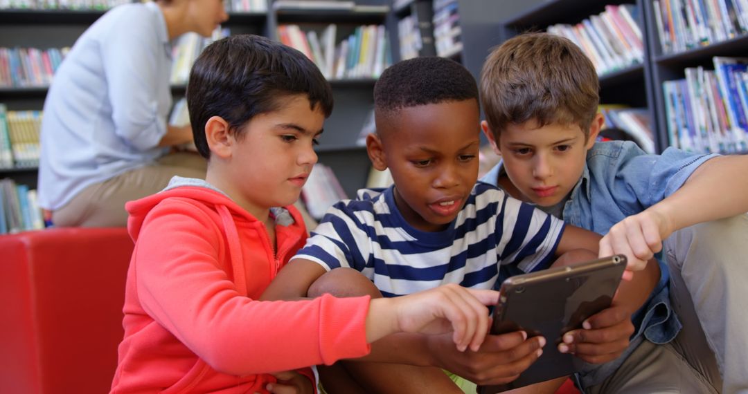 Diverse Students Collaborating on Tablet in School Library