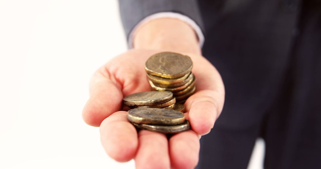 Businessman Holding Stack of Coins in Hand for Financial Concept - Free Images, Stock Photos and Pictures on Pikwizard.com