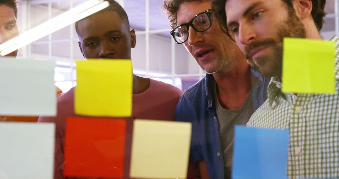 Team Collaborating with Colorful Sticky Notes in Office