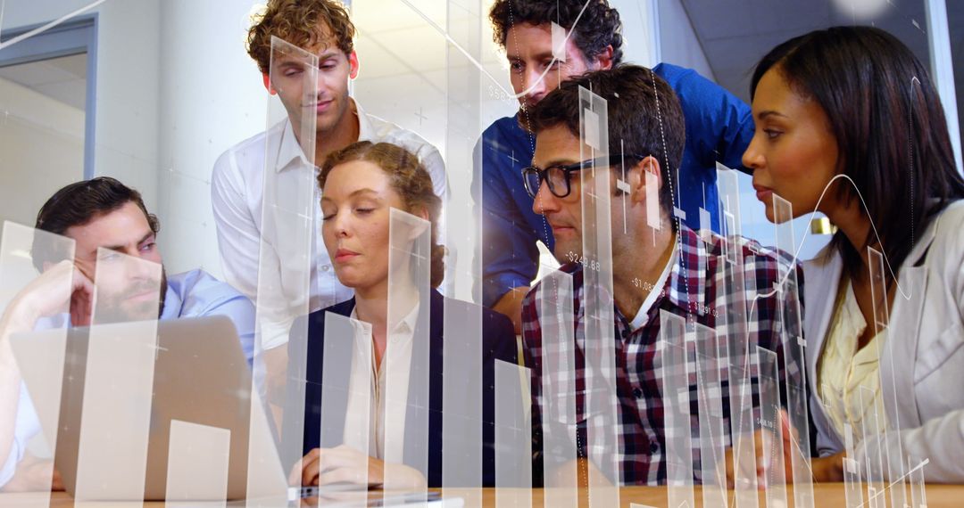 Diverse Team Collaborating on Technology with Financial Data Overlay