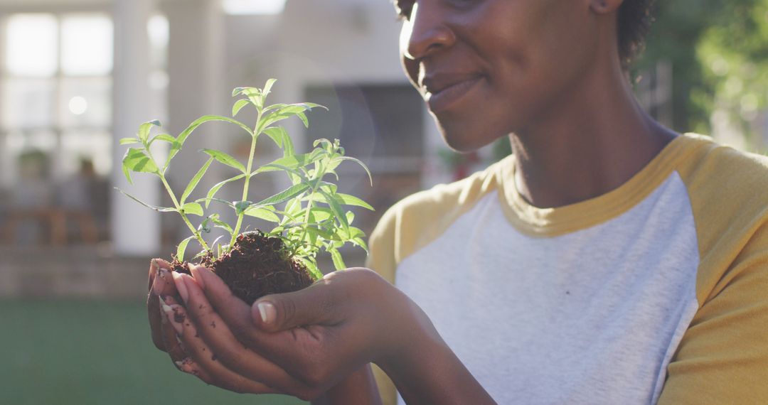 Close-up of Smiling Woman Holding a Seedling in Hands - Free Images, Stock Photos and Pictures on Pikwizard.com