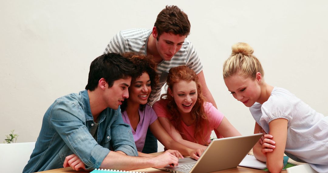 Diverse Group of College Students Collaborating on Laptop - Free Images, Stock Photos and Pictures on Pikwizard.com