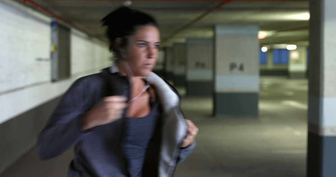 Focused Woman Jogging in Underground Parking Garage - Free Images, Stock Photos and Pictures on Pikwizard.com