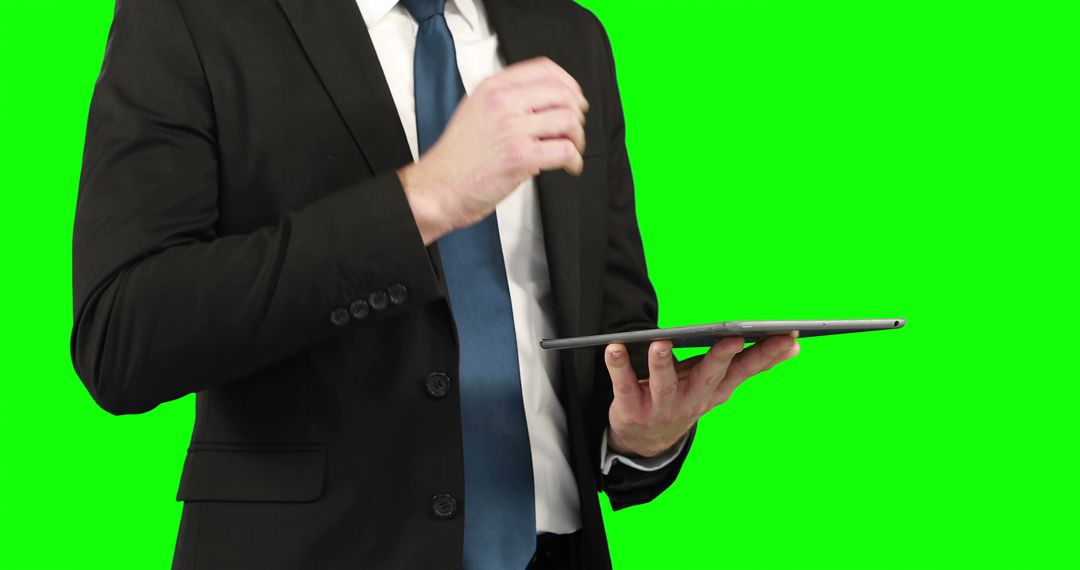 Businessman using his digital tablet on green screen  - Free Images, Stock Photos and Pictures on Pikwizard.com