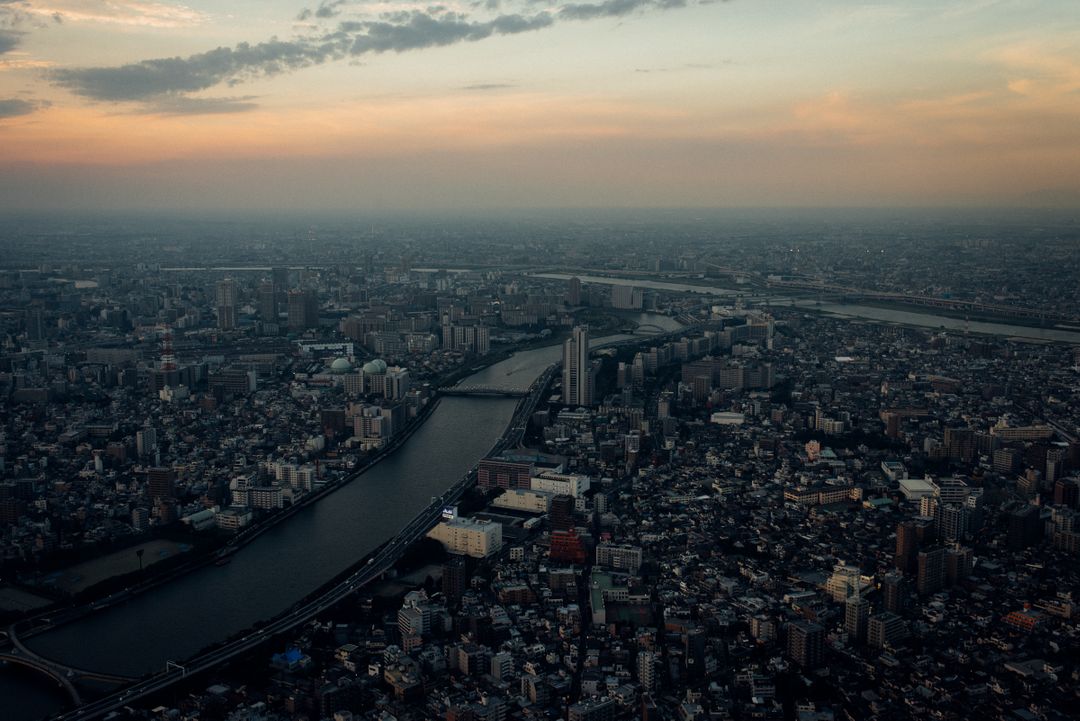 Aerial View of Urban Cityscape at Dusk with River and Buildings - Free Images, Stock Photos and Pictures on Pikwizard.com