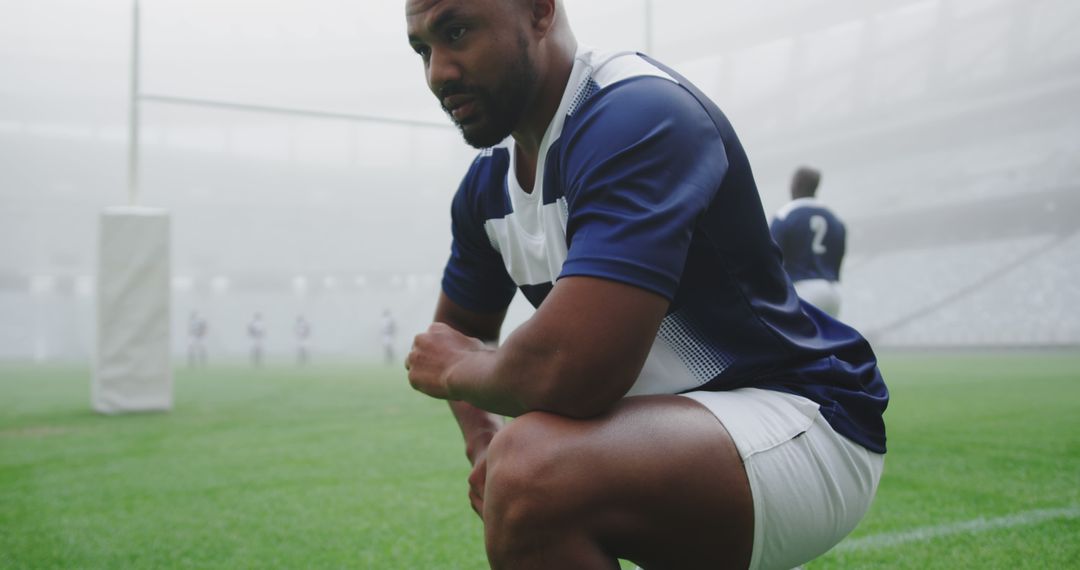 Focused Rugby Player Kneeling on Field Before Match - Free Images, Stock Photos and Pictures on Pikwizard.com