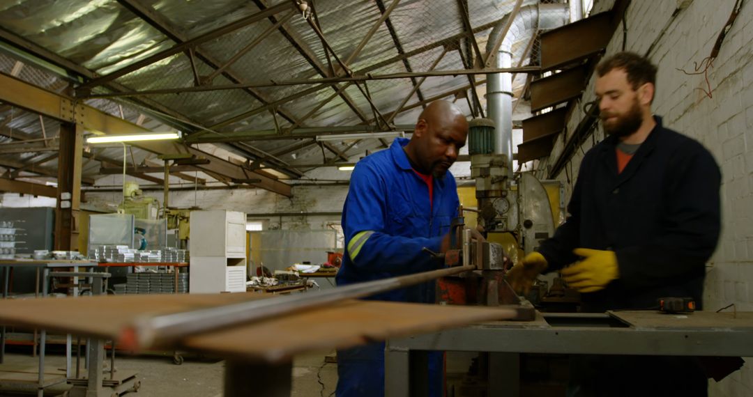 Two industrial workers manufacturing metal structures inside workshop - Free Images, Stock Photos and Pictures on Pikwizard.com