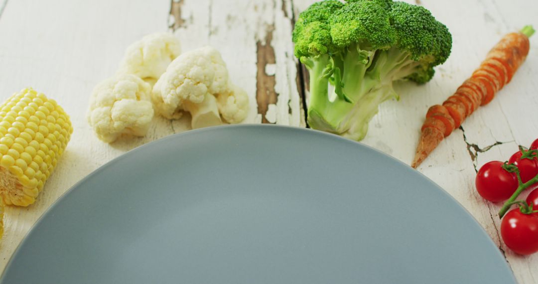 Fresh Vegetables Surrounding Empty Gray Plate on Rustic Table - Free Images, Stock Photos and Pictures on Pikwizard.com