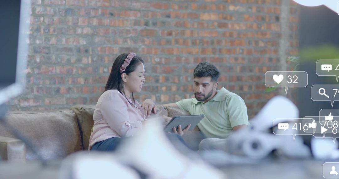 Colleagues Collaborating Using Digital Tablet in Modern Lounge