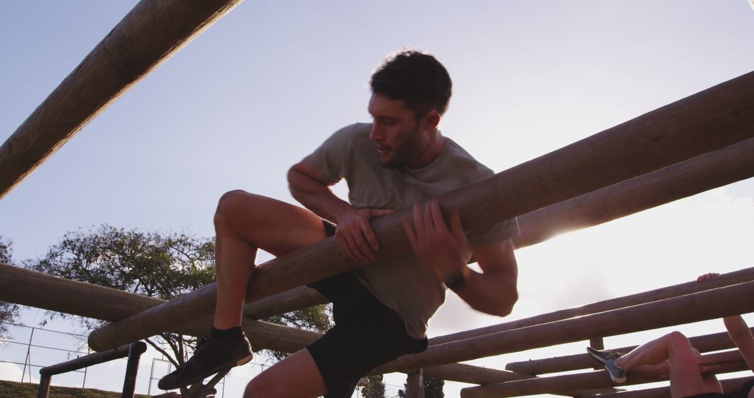 Man Participating in Outdoor Obstacle Course Training During Sunset - Free Images, Stock Photos and Pictures on Pikwizard.com