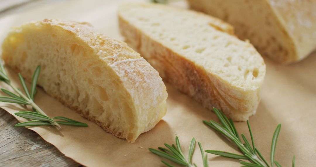 Freshly Baked Bread with Rosemary Springs on Rustic Brown Paper