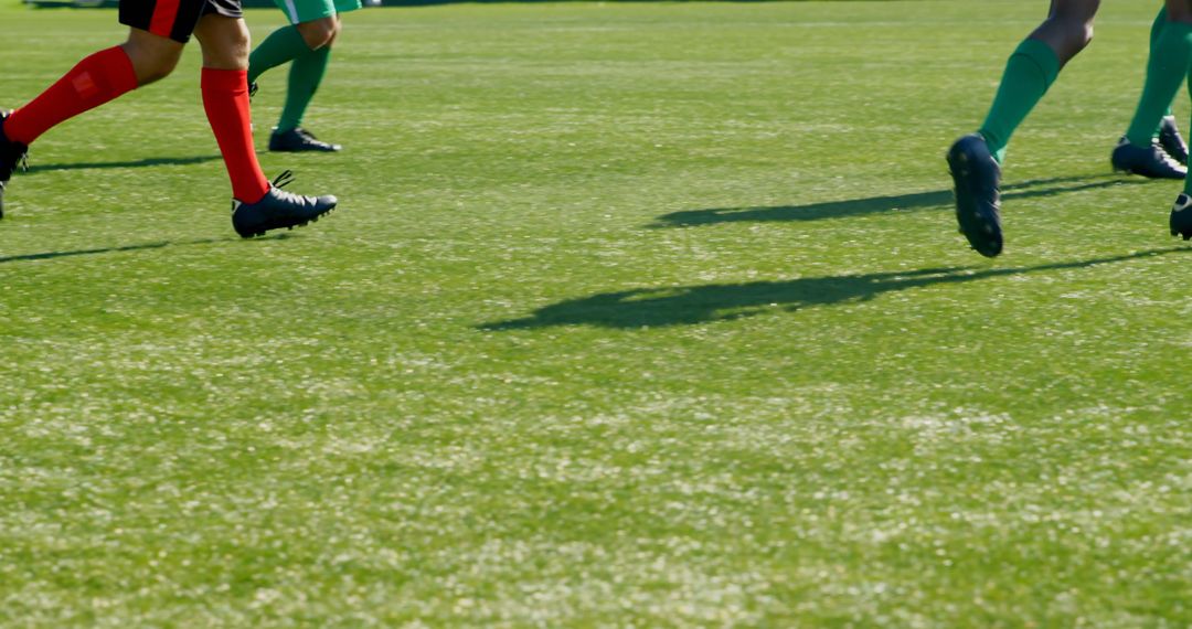 Football Players Running on Green Field During Match - Free Images, Stock Photos and Pictures on Pikwizard.com