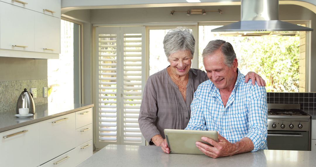 Senior Couple Using Digital Tablet in Modern Kitchen - Free Images, Stock Photos and Pictures on Pikwizard.com