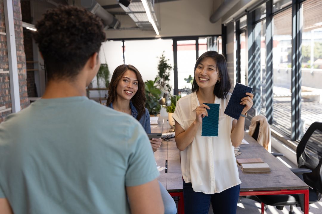 Design Team Collaborating with Fabric Swatches and Tablet