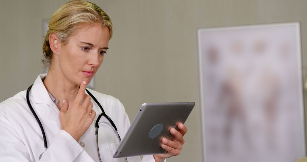 Female Doctor Using Digital Tablet for Diagnosis - Free Images, Stock Photos and Pictures on Pikwizard.com