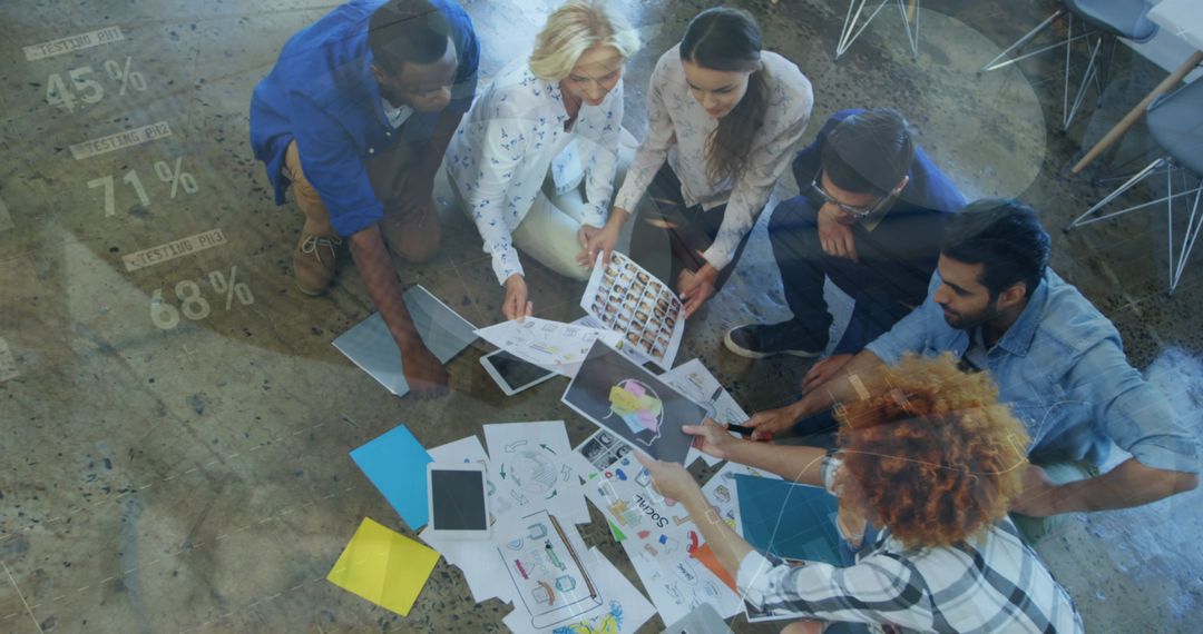 Diverse Team Collaborating on Creative Project with Data Overlay