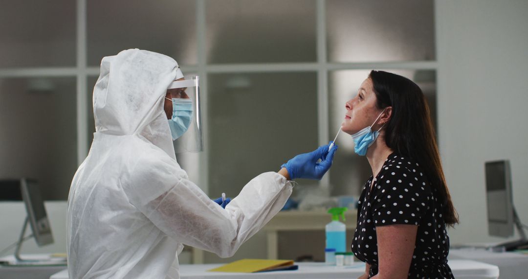 Medical worker in protective clothing taking swab test from female patient - Free Images, Stock Photos and Pictures on Pikwizard.com