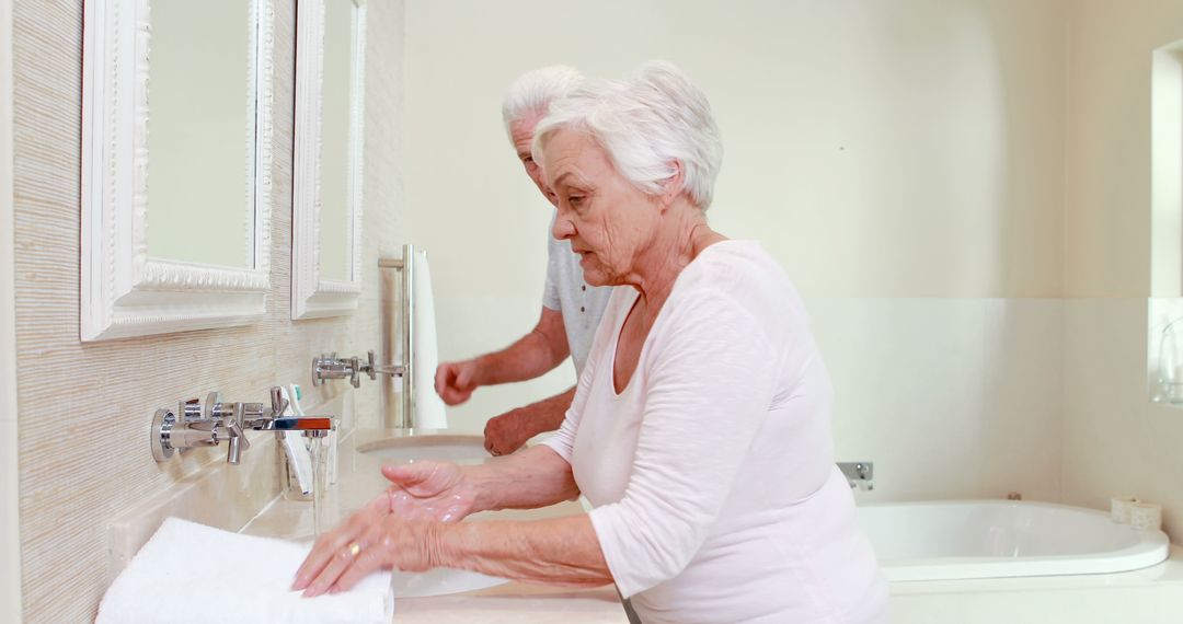 Senior Couple Washing Hands in Modern Bathroom Interior - Free Images, Stock Photos and Pictures on Pikwizard.com