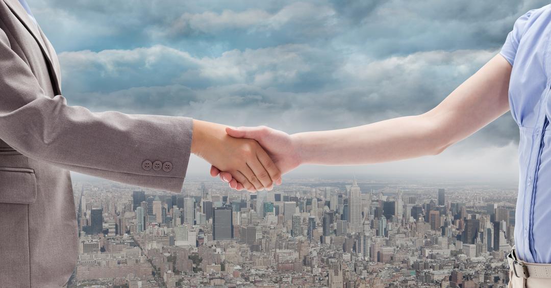 Digitally generated image of  businesswomen doing handshake with city in background - Free Images, Stock Photos and Pictures on Pikwizard.com