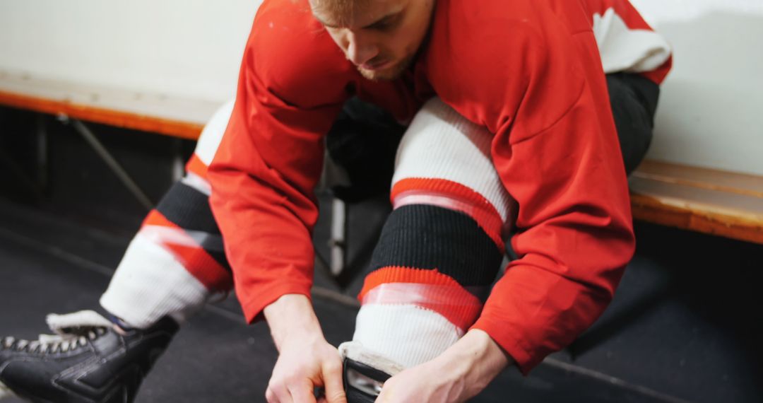 Hockey Player Lacing Skates in Locker Room Before Game - Free Images, Stock Photos and Pictures on Pikwizard.com