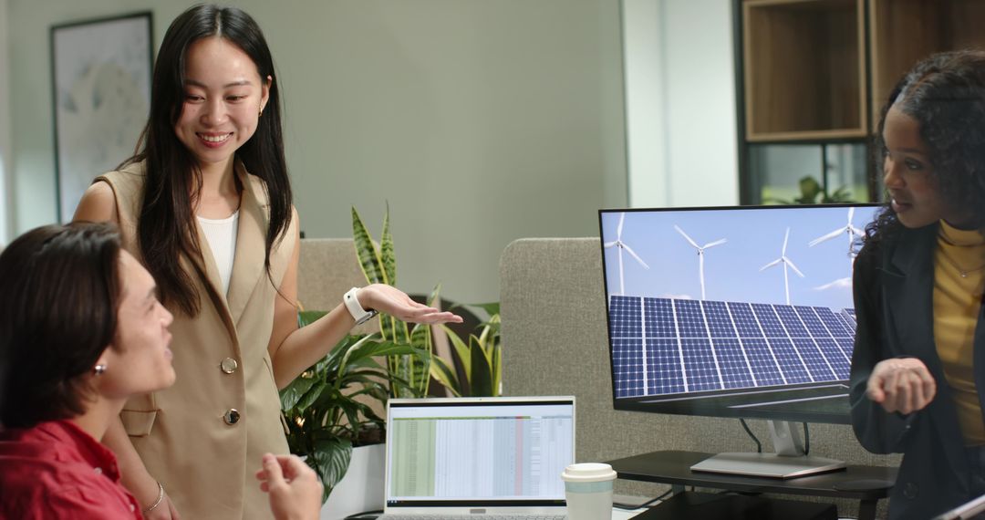 Diverse Female Coworkers Collaborating on Renewable Energy Software