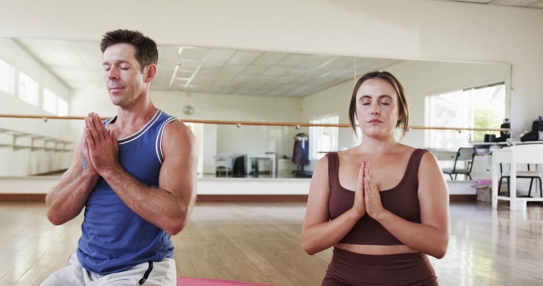 Caucasian Couple Practicing Yoga Meditation in Sunny Studio - Free Images, Stock Photos and Pictures on Pikwizard.com